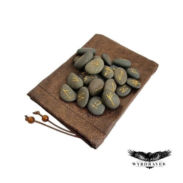 Elder Futhark River Stone Runes tumbling out of a brown, faux leather pouch - Viking Runes - Wyrdraven Runes - wyrdraven.co.uk